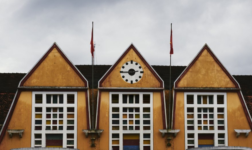 A school building with gabled windows and a clock